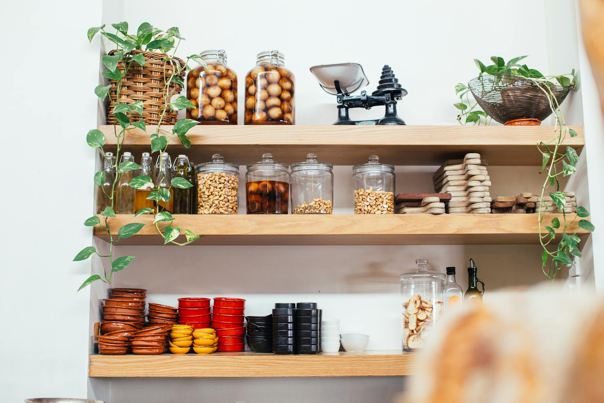 timber shelves with many glass jars filled